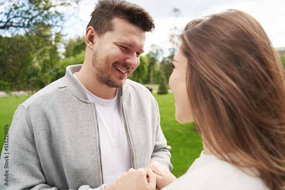 Fototapeta premium Happy couple in love holding hands on the street