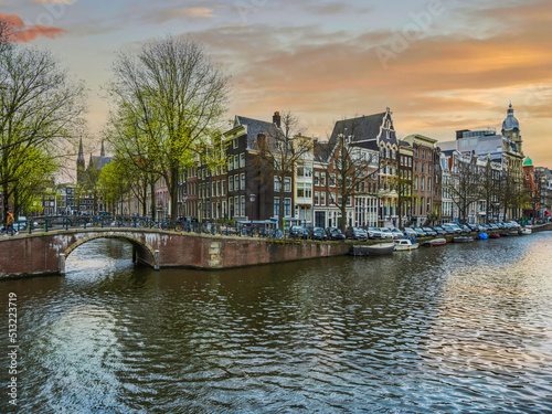 Sticker Canal bridge and colourful Dutch buildigs in Amsterdam, Netherlands