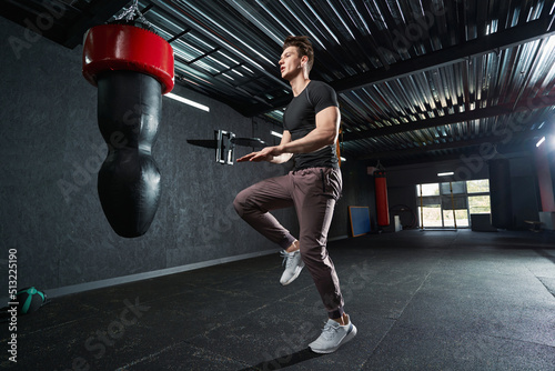 Sportsman performing one-leg jump during plyometric workout © Viacheslav Yakobchuk