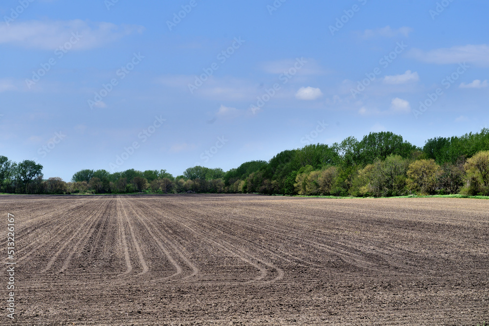 A neatly manicured and prepared field is ready for crop planting in northwestern Illinois. Illinois like most Midwestern US states is deeply steeped in agriculture.