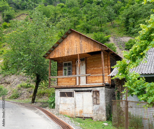 Unusual house in nature. Wooden - concrete house. Reliable country house