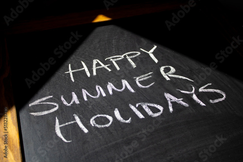 Happy Summer Holidays is on the chalkboard