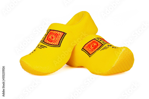 Pair of traditional Dutch yellow wooden shoes over white background. Popular souvenirs. Traditions of Holland
