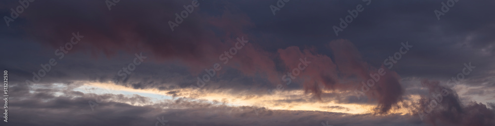 Leaden, storm clouds covered the sunset. Cumuliform cloudscape on blue sky. Tragic gloomy sky.