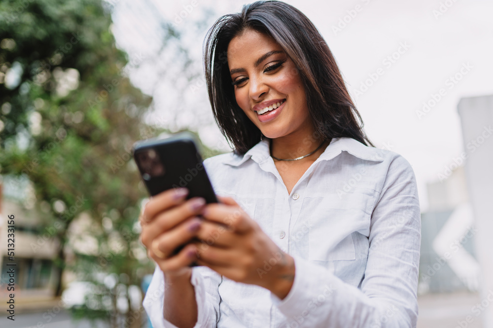 Beautiful Latin girl using her mobile phone. Beautiful Latin girl using her mobile phone.