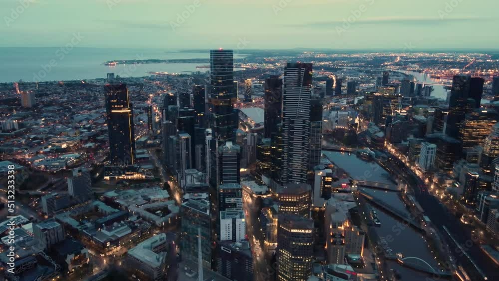 Beautiful aerial drone pullback reverse view of Melbourne City, Victoria, Australia above the Yarra River in the very early morning at dawn 