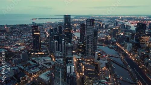 Beautiful aerial drone pullback reverse view of Melbourne City, Victoria, Australia above the Yarra River in the very early morning at dawn 