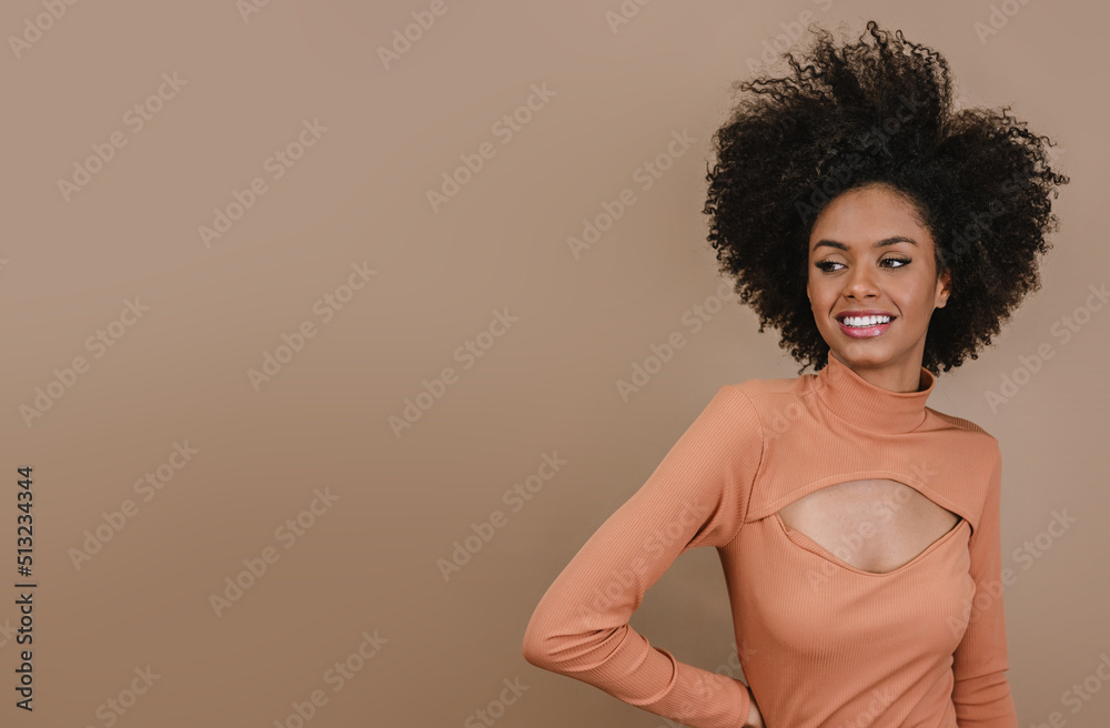 Closeup of a smiling young Latin afro woman. Joy, positive and love. Beautiful african-style hair. Pastel studio background. Closeup of a smiling young Latin afro woman. Joy, positive and love. Beautiful african-style hair. Pastel studio background.