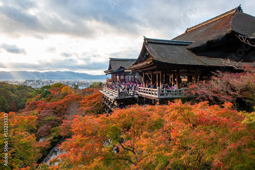 Japan - November 20, 2019 : Tourists enjoy sightseeing vivid maple tree garden in autumn evening at Kiyomizudera Temple, Kyoto