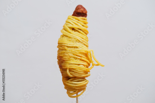 Traditional snack made from sausage covered with fried noodle photo