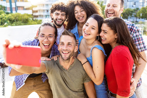 Happy young group of multiracial friends having fun on summer holidays - Millennial friends taking selfie together while laughing outdoors