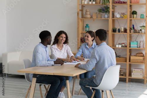 Diverse company teammates gather in office boardroom for negotiations, collaborative project discussion, search business solution look optimistic. Seminar, teamwork, training and seminar event concept