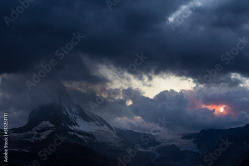 Beautiful storm cloudscape in the Swiss Alps in summer, with Matterhorn peak in the background © Calin Tatu