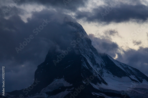 Beautiful storm cloudscape in the Swiss Alps in summer, with Matterhorn peak in the background © Calin Tatu