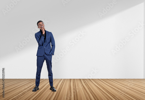 Black businessman with thoughtful look on white background. Copy space