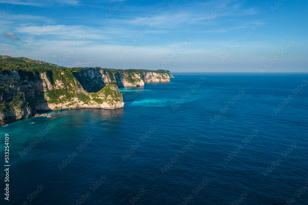 Aerial drone shot panoramic view of rocky cliff. Indian ocean shore. Copy space for text. Nature and travel background. Beautiful natural summer vacation travel concept.