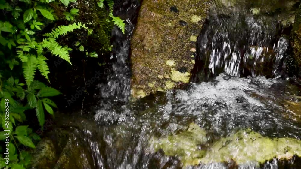 Clear water flowing down a small waterfall 2 Clear water flowing down a small waterfall 2