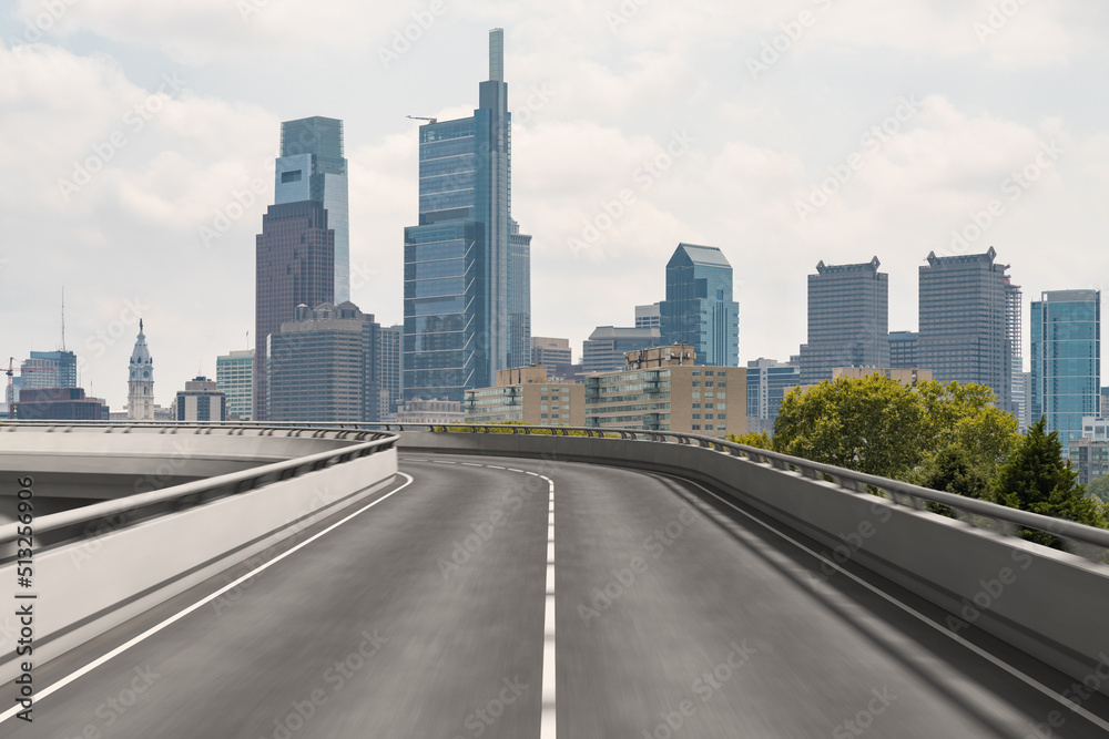 Empty urban asphalt road exterior with city buildings background. New modern highway concrete construction. Concept way to success. Transportation logistic industry fast delivery. Philadelphia. USA.