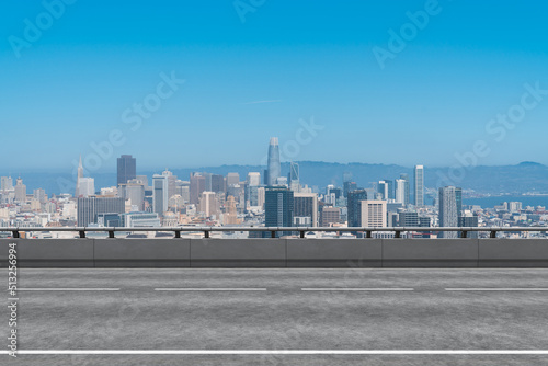 Empty urban asphalt road exterior with city buildings background. New modern highway concrete construction. Concept way to success. Transportation logistic industry fast delivery. San Francisco. USA.