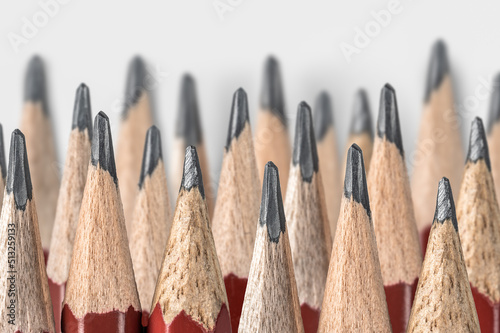 lot of sharpened pencils laid out in several rows. sharpened pencils close up isolated on gray background. Pencil concept business planning