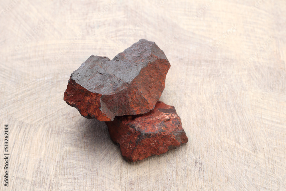 Iron ore stone on a textured wooden base.... Iron ore stone on a textured wooden base....