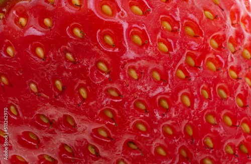 red background of strawberries close-up macro