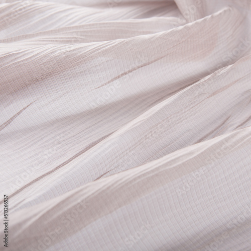 texture of translucent tulle fabric with soft longitudinal folds