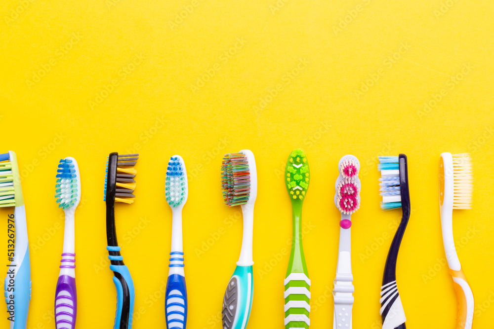 Toothbrushes on a yellow background. Health care, dental hygiene. Space for text. Toothbrushes on a yellow background. Health care, dental hygiene. Space for text.