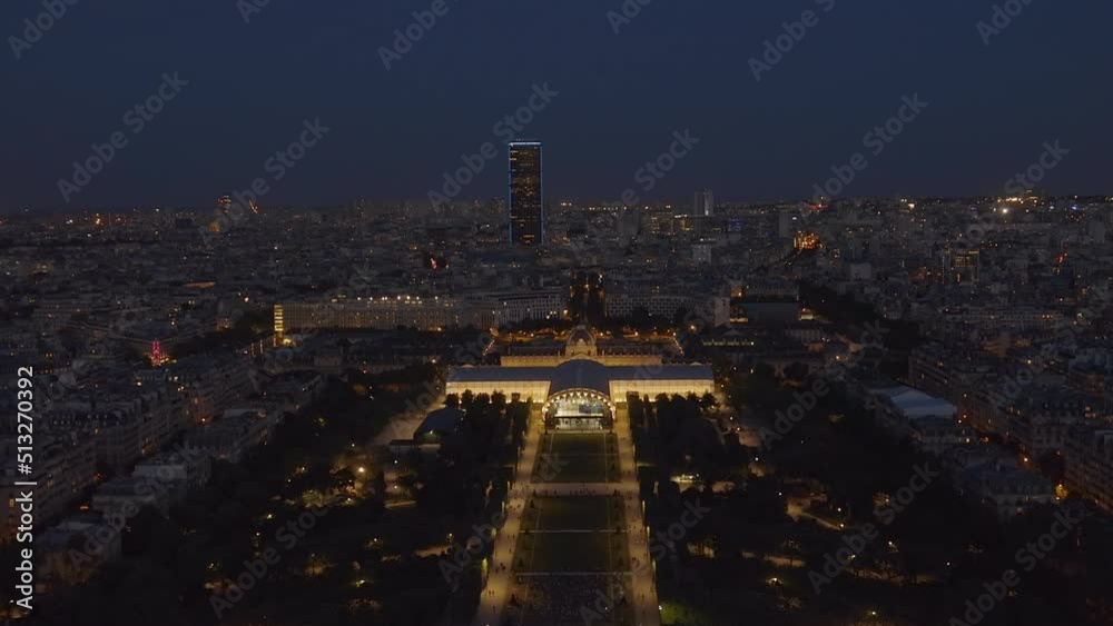 Champs de Mars park and Montparnasse tower seen from the second floor of the Eiffel Tower in Paris, France illuminated at night
