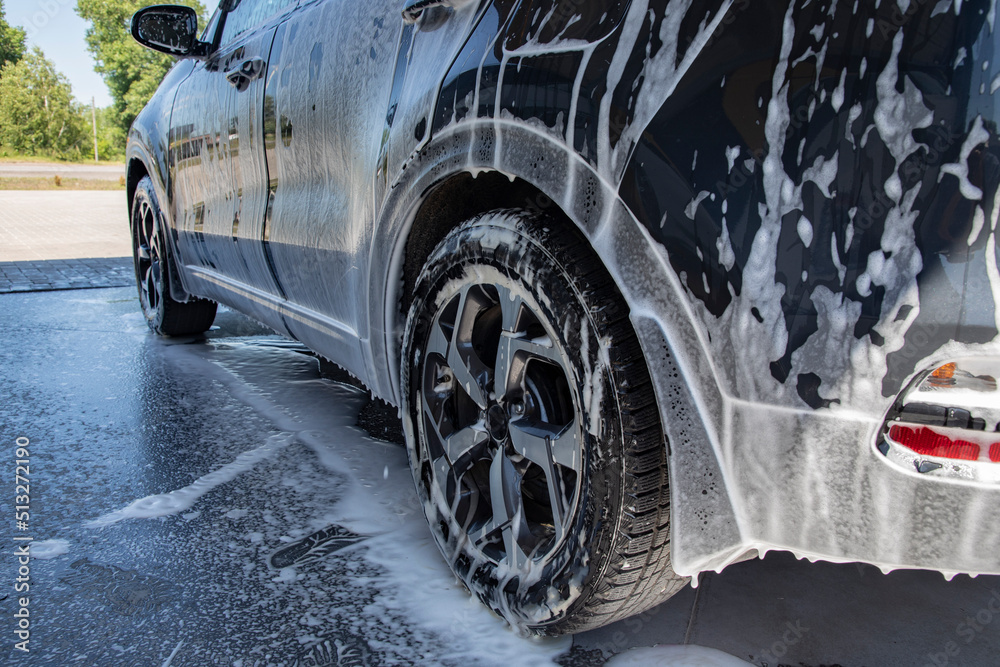 Black car being washed at a car wash