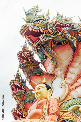 Thai serpent dragon statue with buddha statue