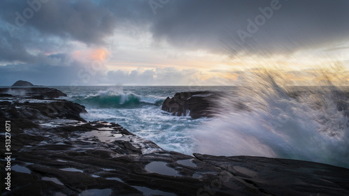 Ocean waves crashing on rocks at Muriwai beach  Auckland.
