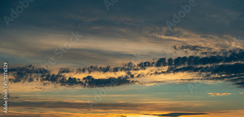 Tropical dawn sky with clouds in golden hues © SDF_QWE