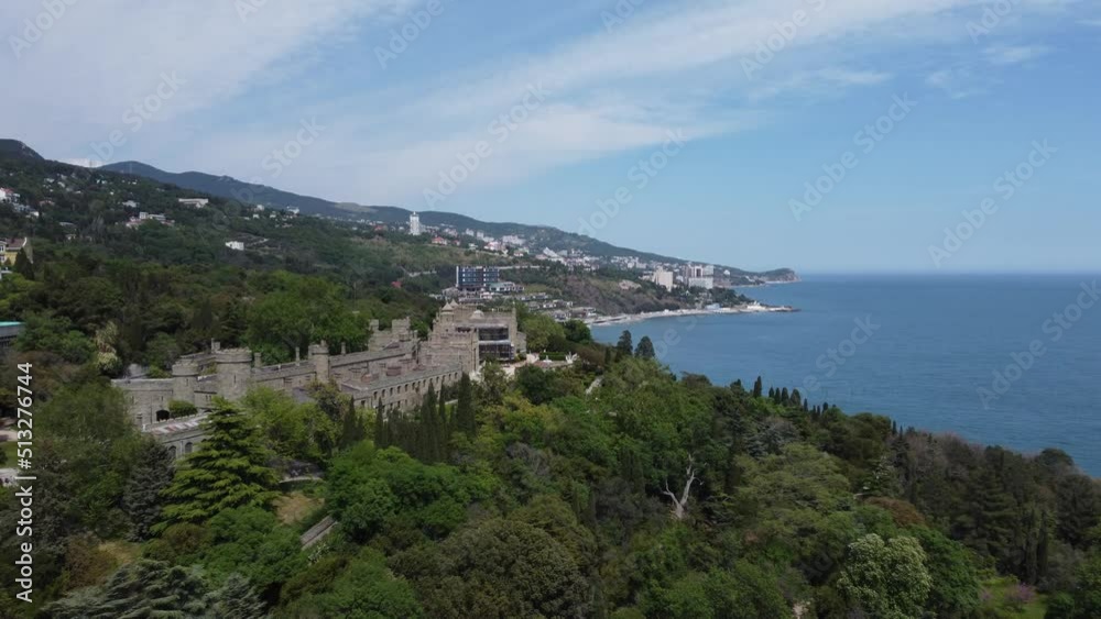 Alupka, Crimea. Aerial view on Vorontsov Palace. 19th century Gothic mansion with well-preserved halls and picturesque park. The palace was built from 1828 to 1848. Travel point of interest Alupka, Crimea. Aerial view on Vorontsov Palace. 19th century Gothic mansion with well-preserved halls and picturesque park. The palace was built from 1828 to 1848. Travel point of interest
