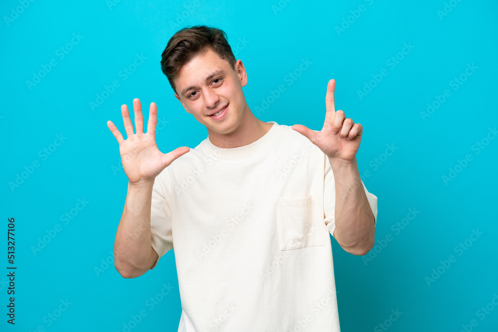 Young handsome Brazilian man isolated on blue background counting seven with fingers Young handsome Brazilian man isolated on blue background counting seven with fingers