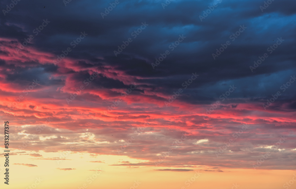 Swirling evening clouds illuminated by the setting sun