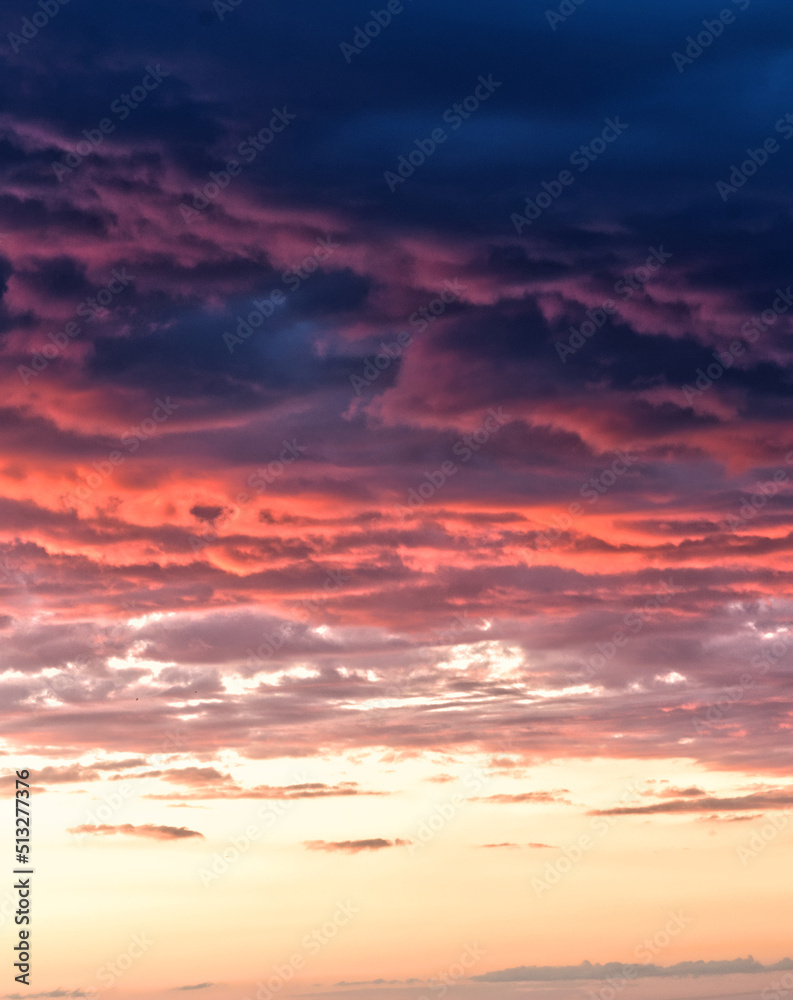 Swirling evening clouds illuminated by the setting sun