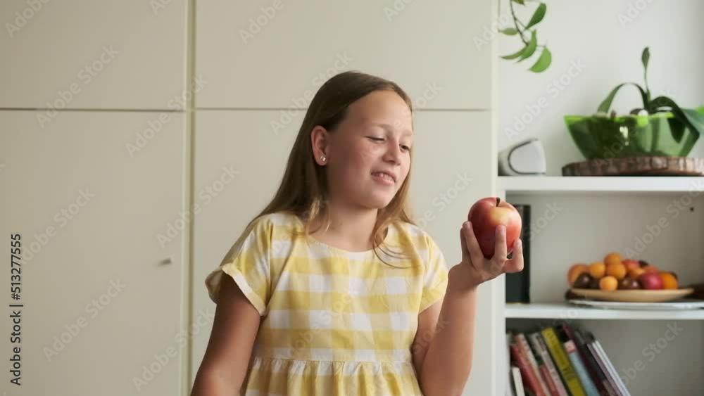 the girl chooses between a cupcake and an apple