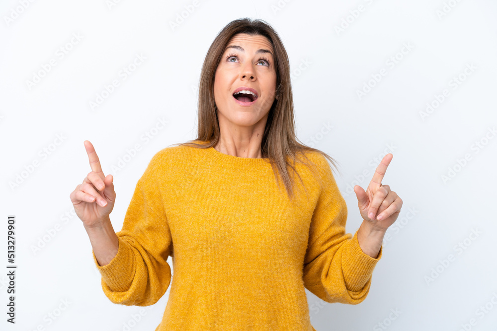 Middle age caucasian woman isolated on white background surprised and pointing up Middle age caucasian woman isolated on white background surprised and pointing up