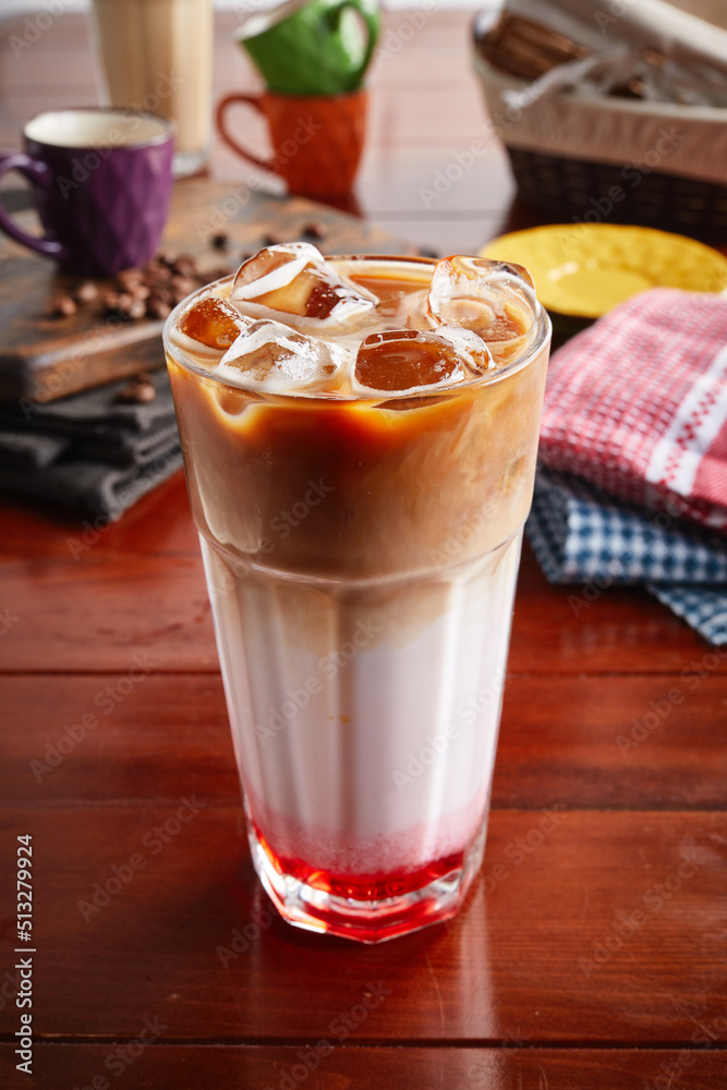 A glass of healthy fresh RED VELVET COFFEE isolated on wooden background side view A glass of healthy fresh RED VELVET COFFEE isolated on wooden background side view