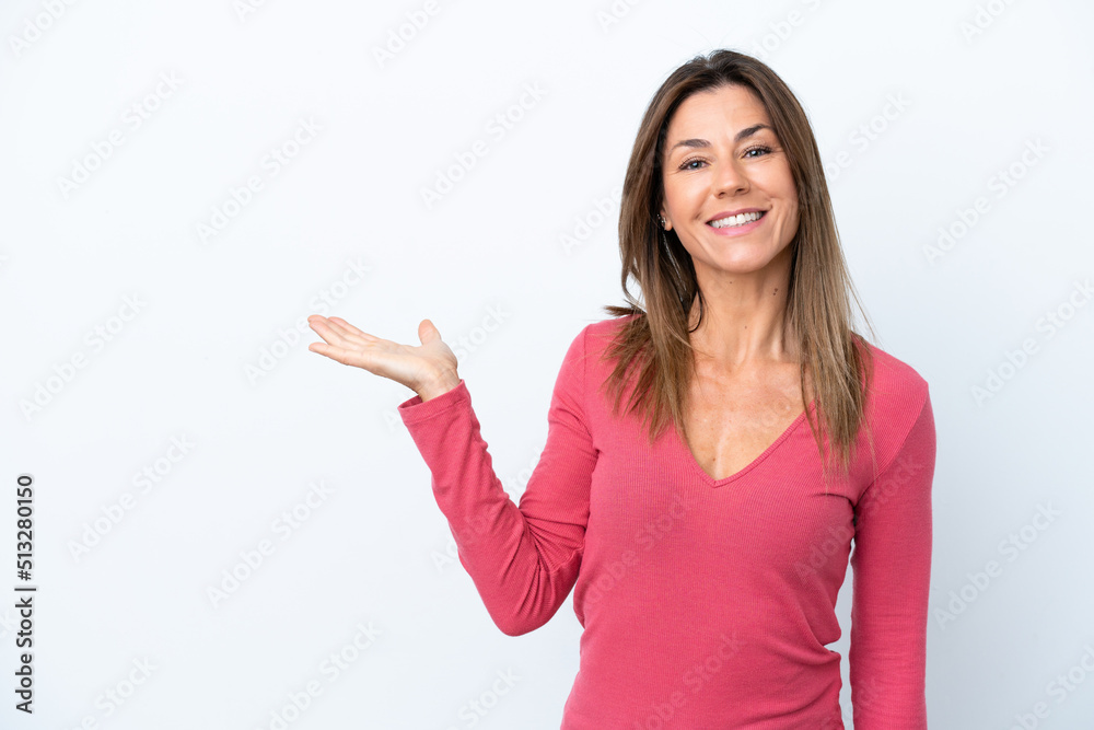 Middle age caucasian woman isolated on white background holding copyspace imaginary on the palm to insert an ad Middle age caucasian woman isolated on white background holding copyspace imaginary on the palm to insert an ad