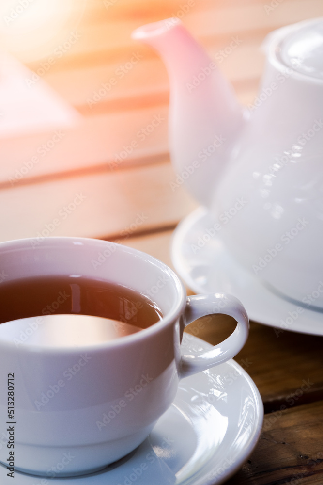 Cup of tea with teapot on wood table cafe Cup of tea with teapot on wood table cafe