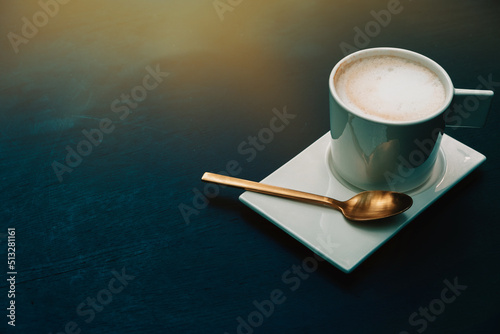 stylish white cup of cappuccino with latte art on black table