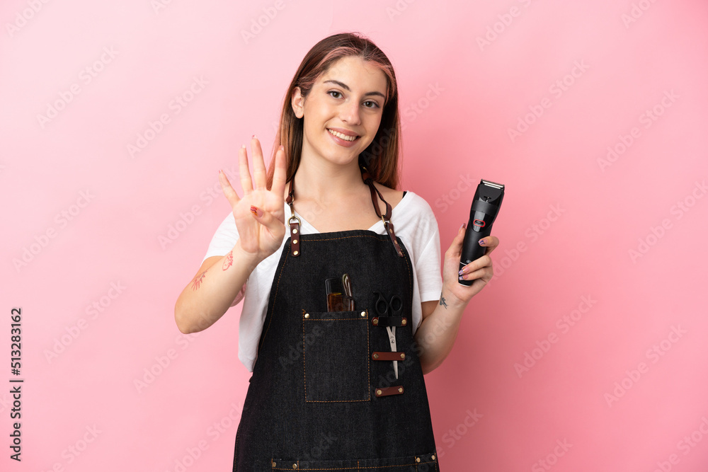 Young hairdresser woman isolated on pink background happy and counting four with fingers Young hairdresser woman isolated on pink background happy and counting four with fingers