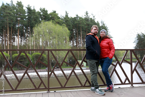 Couple posing on bank of pond