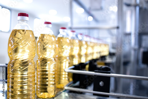 Sunflower vegetable oil in bottles being produced in food factory.