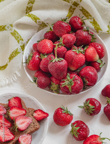 Sweet healthy breafast with lots of fresh strawberries on a table with napkin. Healthy eating concept. photo