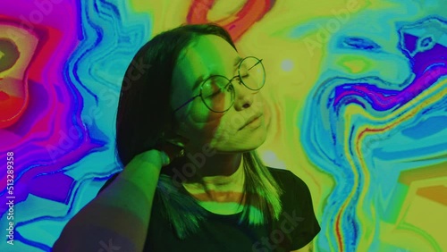 Young woman moving, turns head slowly in altered state of consciousness. Girl is in narcotic or alcoholic intoxication, under influence of psychotropic substances. Hallucinations, drug dependence