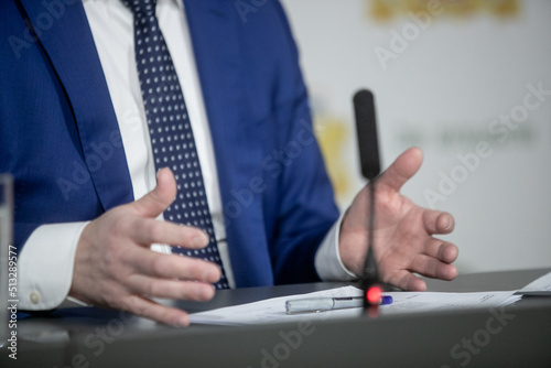 Businessman or politician giving inteview. Close up view gesticulating hands of business man. photo