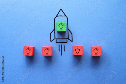 Cube with idea lightbulb took off on rocket. Developing startup, best idea. Business accelerator.